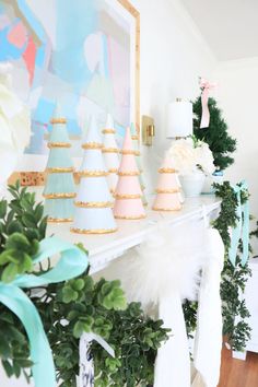 there are many small trees on the mantle in this room, and one is decorated with pastel colors