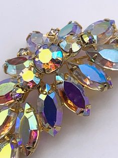 Elegant Multicolor Brooches For Evening, Elegant Rainbow Rhinestone Jewelry, Elegant Multicolor Jeweled Brooches, Elegant Multicolor Rhinestone Brooches, Gold Crystal Brooches For Party, Multicolor Brooch Jewelry For Evening, Multicolor Brooch For Evening Wear, Party Crystal Brooches Costume Jewelry, Multicolor Party Jewelry With Brooch