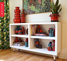 a white shelf filled with vases and books