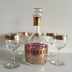 an empty wine bottle sitting on top of a table next to glasses