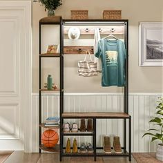 a shelf with shoes, t - shirts and other items on it in a room