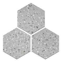 three hexagonal tiles with speckles on the top one is grey and the other is white