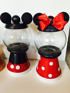 three mickey mouse gumpers with red bows on their heads and one has a black bow