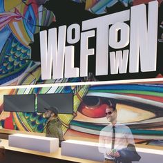 a man standing in front of a colorful wall with the words wifon on it