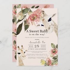 a baby shower is on the way with pink flowers and giraffe's