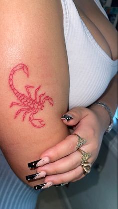 a woman's stomach with a scorpion tattoo on it