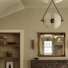 a living room filled with furniture and a fire place next to a mirror on the wall