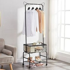 a rack with shoes and shirts hanging on it in a living room next to a chair