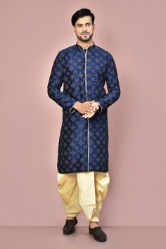 Navy blue cotton kurta with all over floral geometric pattern, mandarin collar, contrast zari and thread embroidery. Paired with cream pleated cowl draped dhoti pants.
Components: 2
Pattern: Embroidered
Type Of Work: Thread and Zari Work
Neckline: Mandarin Collar
Sleeve Type: Full Sleeves
Fabric: Cotton
Color: Blue
Other Details: 
Front potli buttons
Contrast piping details
Closure:
Kurta: Front loop buttons
Dhoti: Front drawstrings
Occasion: Sangeet - Aza Fashions Diwali Bandhgala With Zari Weaving, Traditional Drape Kurta For Eid, Designer Sherwani With Zari Weaving In Traditional Drape, Festive Bandhgala With Zari Weaving And Traditional Drape, Traditional Drape Kurta With Zari Weaving For Navratri, Traditional Drape Kurta For Festive Occasions, Blue Cotton Silk Sherwani For Festivals, Diwali Kurta With Dabka Embroidery, Cotton Silk Sherwani For Navratri Festivities