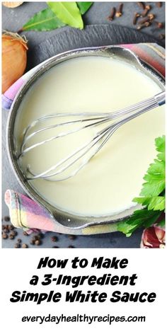 a metal bowl filled with white sauce and whisk