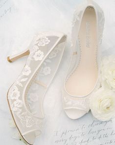 wedding shoes and flowers on a white sheet