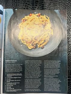 an open magazine with spaghetti and sauce on it