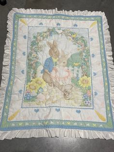 a quilt with a bunny and rabbit on it