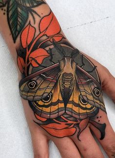 a hand with a butterfly tattoo on it