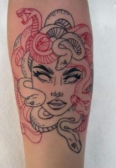 a woman's face with snakes around her head on the thigh, and an arm tattoo