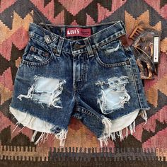 Western biker high waisted Levi's cut off jean holy shorts with leather patchwork  Such a fun pair of shorts I wish they fit me  Great for everyday wear and could be dressed up as a cowboy costume  Good condition  Waist 22 inches xxsmall  Bundles welcomed  Shipping is $6 USA #vintage #western #biker #levis #jeanshorts Levi's Denim Cutoff Shorts, Levi's Cutoff Denim Blue Shorts, Short Jeans Farm, Levi's Mid-rise Shorts With Button Closure, Cowboy Costume, Levi's Short Bottoms With Built-in Shorts, Leather Patchwork, Cut Off Jeans, Leather Shorts