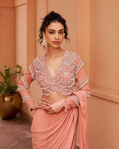 Elevate your style with this stunning peach lehenga sari. The embroidered pallu adds a touch of elegance, while the heavily embroidered blouse enhances its luxurious appeal. Perfect for special occasions, this ensemble seamlessly blends traditional charm with contemporary sophistication. Lehenga Sari, Peach Lehenga, Wedding Fits, Peach Saree, Royalty Aesthetic, Dress Indian, Dress Indian Style, Indian Attire, Indian Outfit