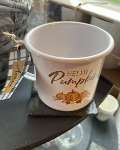 a hello pumpkin cup sitting on top of a table next to a bag of chips