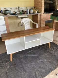 a white chair sitting on top of a wooden table