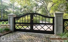 an iron gate and brick walkway leading to a driveway