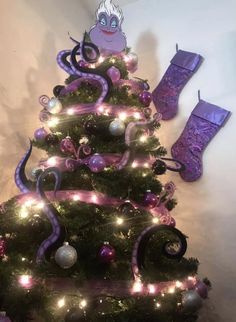 a decorated christmas tree with purple decorations