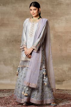 Grey kurta with placement floral embroidery. Comes with printed sharara pants and dupatta.
Components: 3
Fabric: Chanderi, Organza
Neckline: Round
Sleeve Length: Bracelet
Color: Grey
Printed, Embroidered
Kurta with side criss cross tie-up
Sheer panels
Sharara with embroidered hem
Dupatta with tassels
Closure: Kurta: Front loop buttons - Aza Fashions Embroidered Sharara, Sharara Pants, Kurta Sharara Set, Kurta Sharara, Round Bracelet, Sharara Set, Organza Dupatta, Pernia Pop Up Shop, Grey Prints