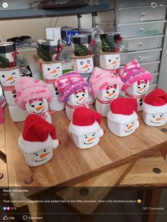 there are many snowmen with hats on the table