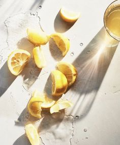 an instagram with lemons and a glass of orange juice on the left side