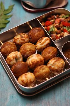 two tins filled with food sitting on top of a table