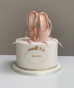 a white cake with pink shoes on top