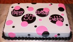 a birthday cake decorated with polka dots and the number 50 on it's side