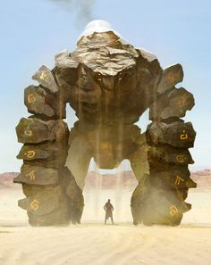 a man standing in front of a giant rock formation