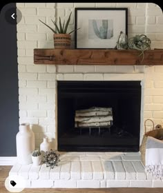 a white brick fireplace in a living room with potted plants on the mantel