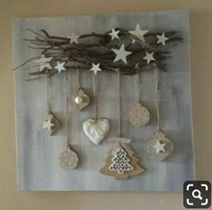 a wall hanging with ornaments and stars on it's side, in the shape of christmas trees