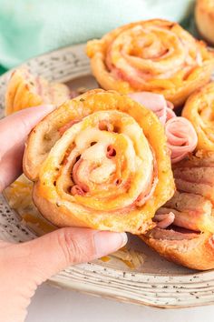 a person is holding some food in their hand and it looks like they have spirals on them