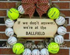 a wreath made out of baseballs with the words, if we don't answer, we're at the ballfield