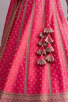 Candy pink raw silk lehenga with cutdana worked temple border, striped pattern, floral motifs and cutwork hem. Comes with blouse and pink cherry ombre organza dupatta.
Components:3
Embroidered
Neckline:Square
Sleeve Length:Half
Fabric:Raw Silk; Dupatta: Organza
Color:Pink

Tie-up cutout back
Cutwork detail
Kamar tassels
Note: Cancan worn by the model is not for sale
 - Aza Fashions Pink Raw Silk Lehenga, Organza Embroidery, Raw Silk Lehenga, Anushree Reddy, Pink Ties, Embroidered Neckline, Organza Dupatta, Silk Dupatta, Cut Work