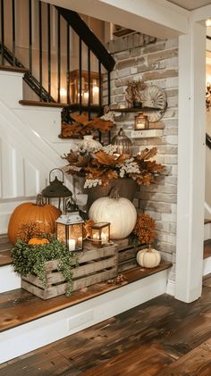 a staircase with pumpkins, candles and other decorations on the bannister ledge