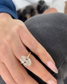 a woman's hand with a diamond ring on it