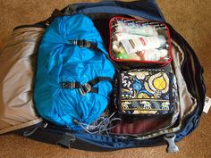 the contents of a backpack are packed and ready to go into the bag on the floor