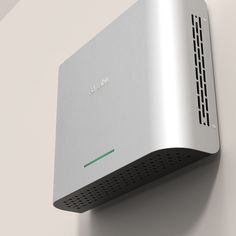 an electronic device mounted to the side of a wall on a white wall with green accents