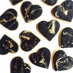 heart shaped cookies with gold splatters on them