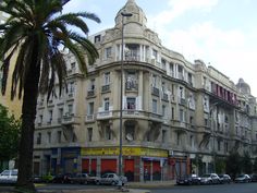 an old building with cars parked on the street