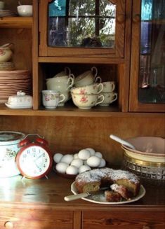 an old china cabinet filled with dishes and eggs