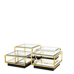 three glass and brass coffee tables on white background