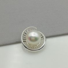 ▪︎ An elegant pendant made with a pearl on a sterling silver base. ▪︎ Size: 12 mm x 18 mm. Pearl size: 10mm Weighs: 3 gm ▪︎ This multi purpose pendant can be used as a charm in necklaces, bracelets, key chains, zip pullers etc. ▪︎ This pendant is handmade with hypoallergenic sterling silver. Most of my pieces are marked with a 925 silver stamp. ▪︎ Please note: This listing is for ONE pendant and comes WITHOUT the chain, however, you can add a snake chain in the required length while making your Silver Jewelry With Round Pearl Pendant, White Oval Pendant Pearl Necklace As Gift, White Pendant Jewelry Stamped 925, Silver Pearl Necklace With Pendant For Anniversary, Hallmarked Pearl Pendant Necklace Gift, Silver Pendant Pearl Necklace For Anniversary, Silver Pendant Jewelry With Pearl Charm, White Sterling Silver Jewelry With Pearl Charm, Silver Sterling Silver Pearl Pendant Necklace