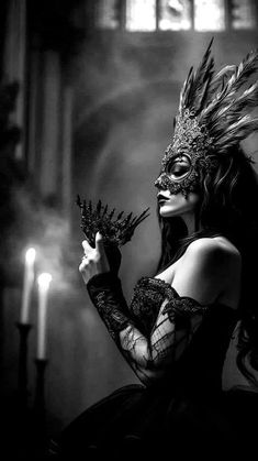 a woman wearing a mask and holding a candle