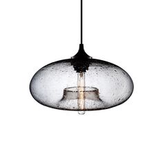 a glass light hanging from a ceiling fixture