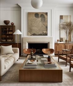 a living room filled with furniture and a fire place in the middle of a room