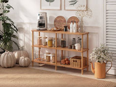 a coffee bar in a living room with pumpkins and other items on the shelf